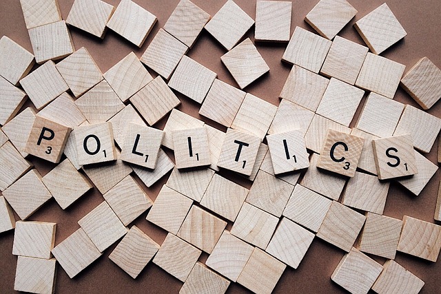 Politics written with Scrabble pieces.